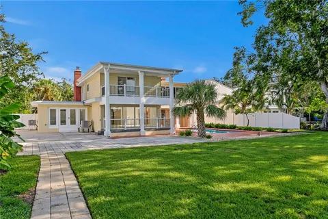 a front view of a house with garden and patio