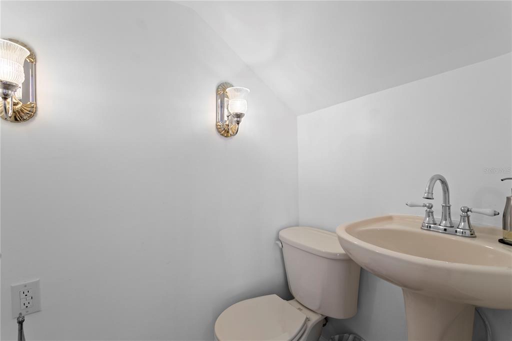 234 Driftwood Road Southeast St. Petersburg, FL 33705 - Photo 56 of 66 a bathroom with a toilet a sink and mirror