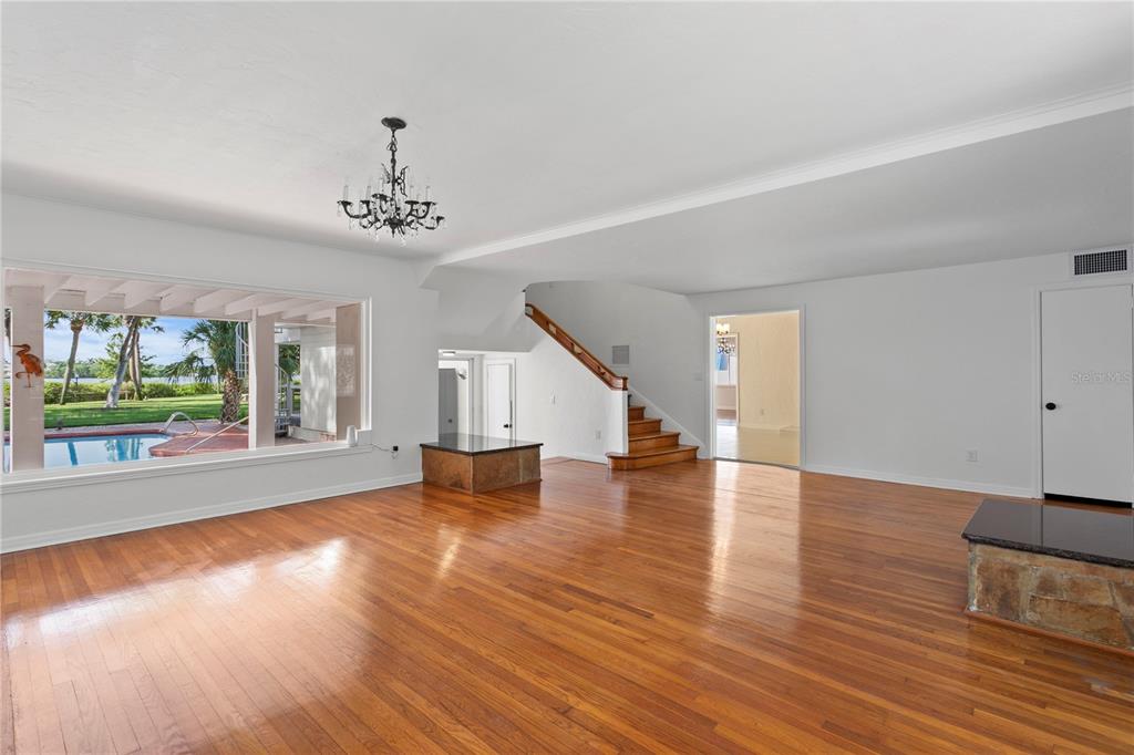 234 Driftwood Road Southeast St. Petersburg, FL 33705 - Photo 9 of 66 a view of empty room with wooden floor and fan