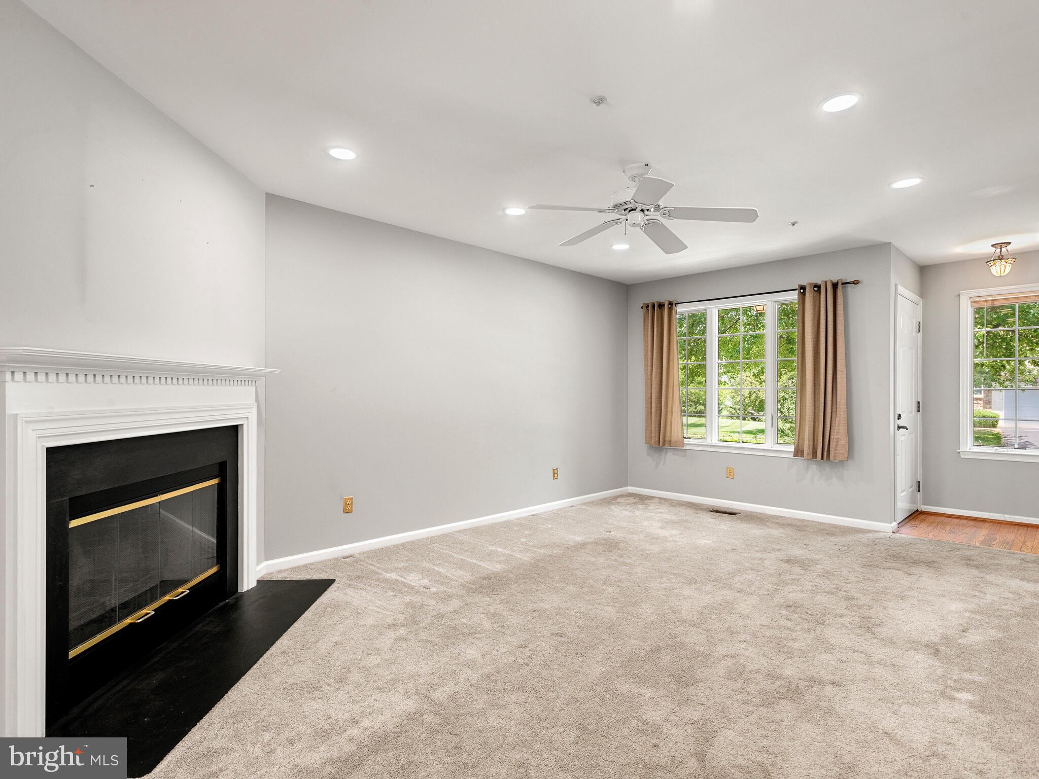 77 Buttonwood Drive, Unit 77 Exton, PA 19341 - Photo 11 of 29 an empty room with windows and fireplace