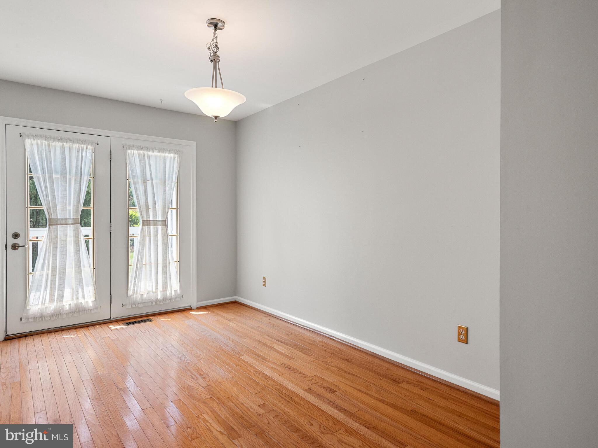 77 Buttonwood Drive, Unit 77 Exton, PA 19341 - Photo 12 of 29 a view of an empty room with wooden floor and a window