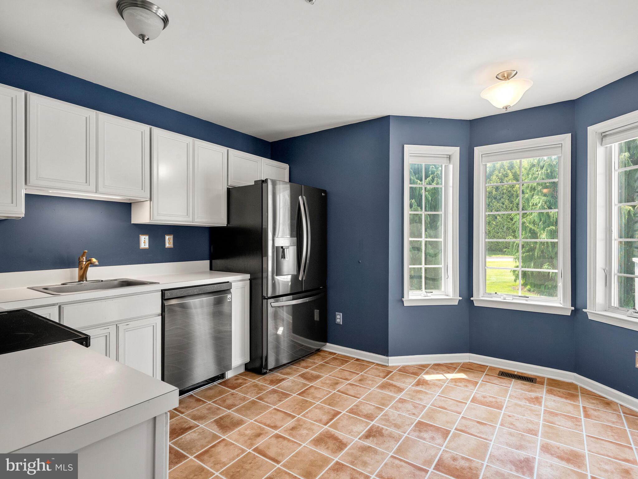 77 Buttonwood Drive, Unit 77 Exton, PA 19341 - Photo 16 of 29 a kitchen with a refrigerator sink and cabinets
