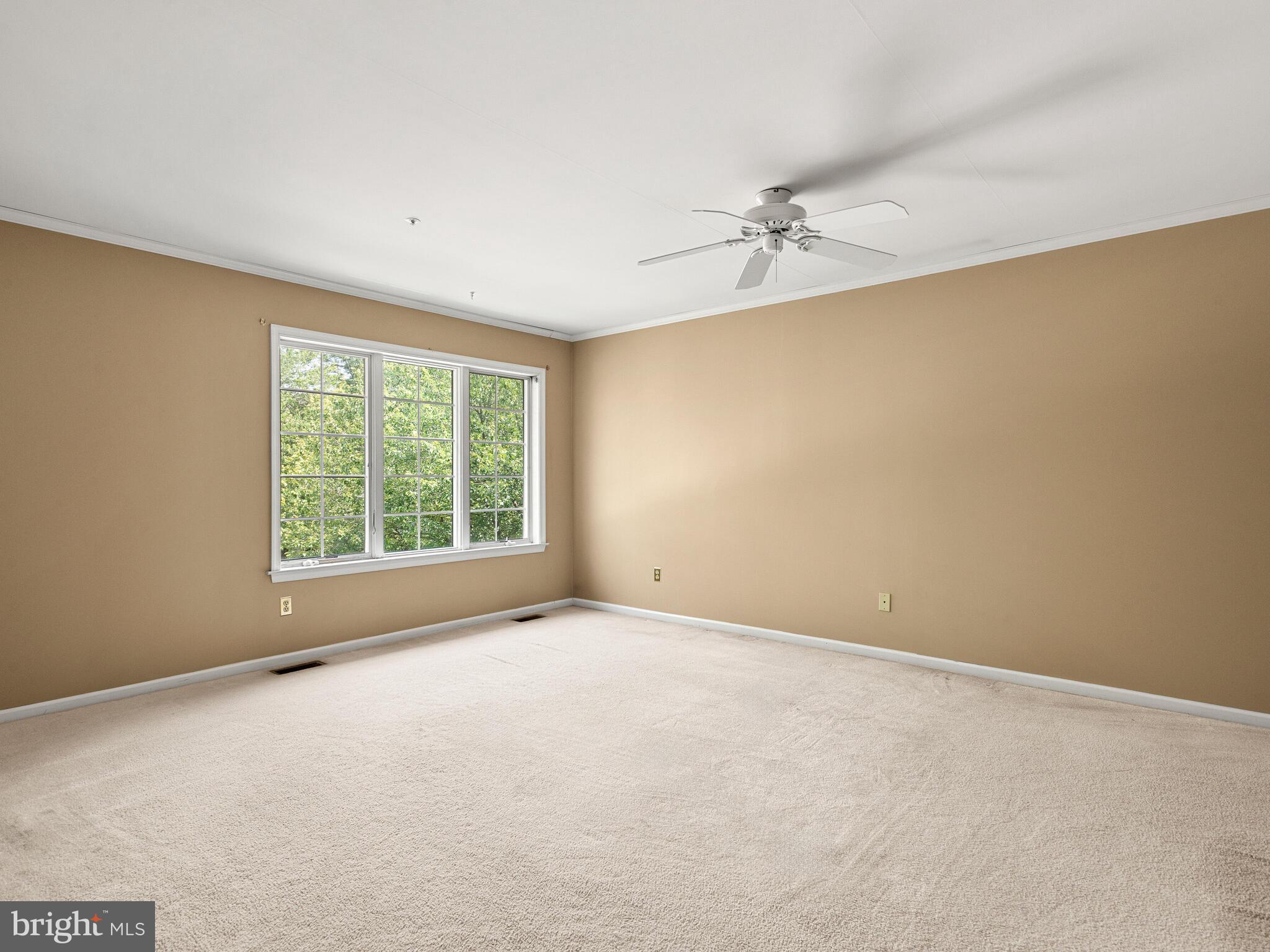 77 Buttonwood Drive, Unit 77 Exton, PA 19341 - Photo 18 of 29 an empty room with a window and a fan