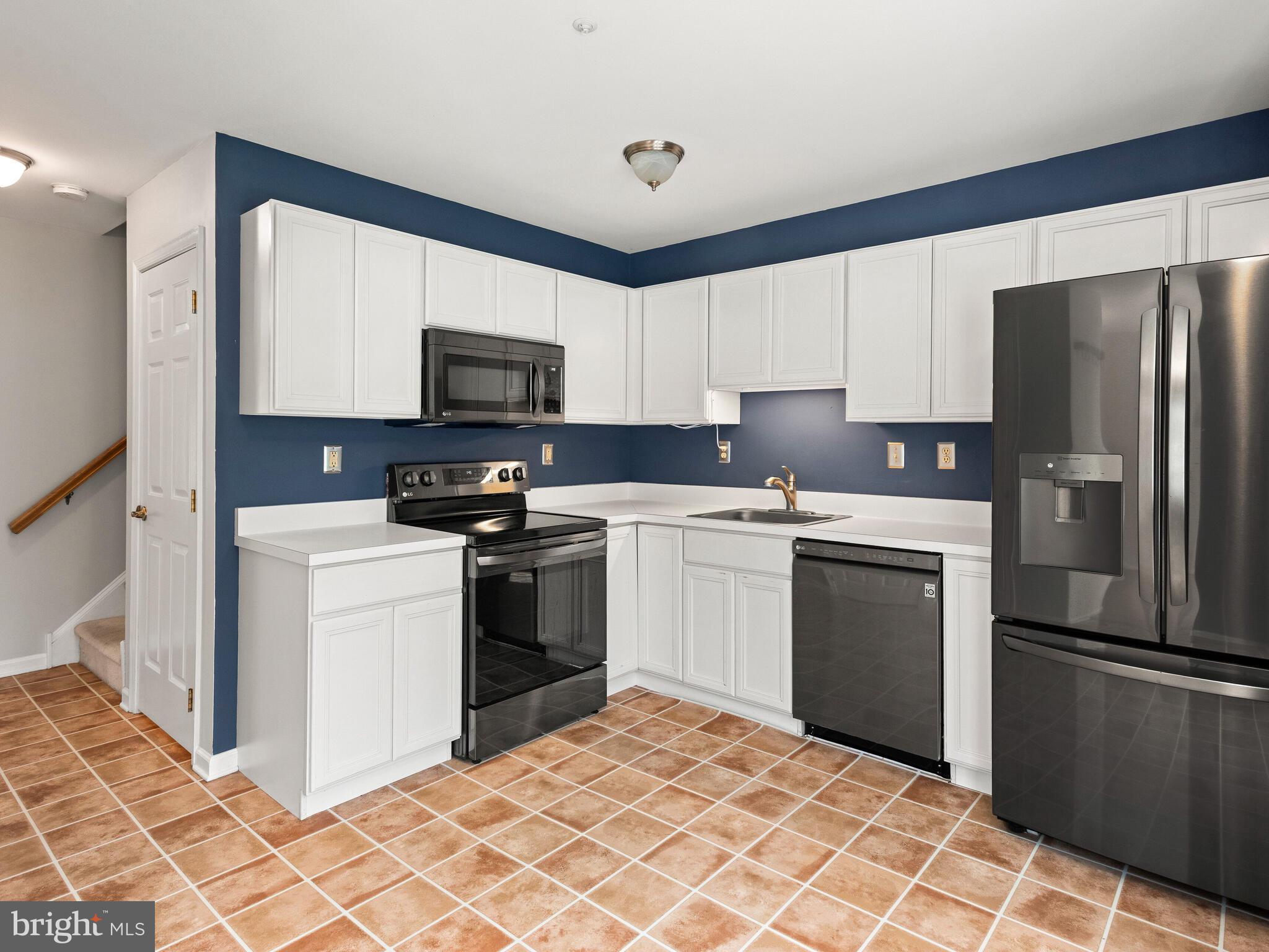 77 Buttonwood Drive, Unit 77 Exton, PA 19341 - Photo 2 of 29 a kitchen with a sink stove and refrigerator