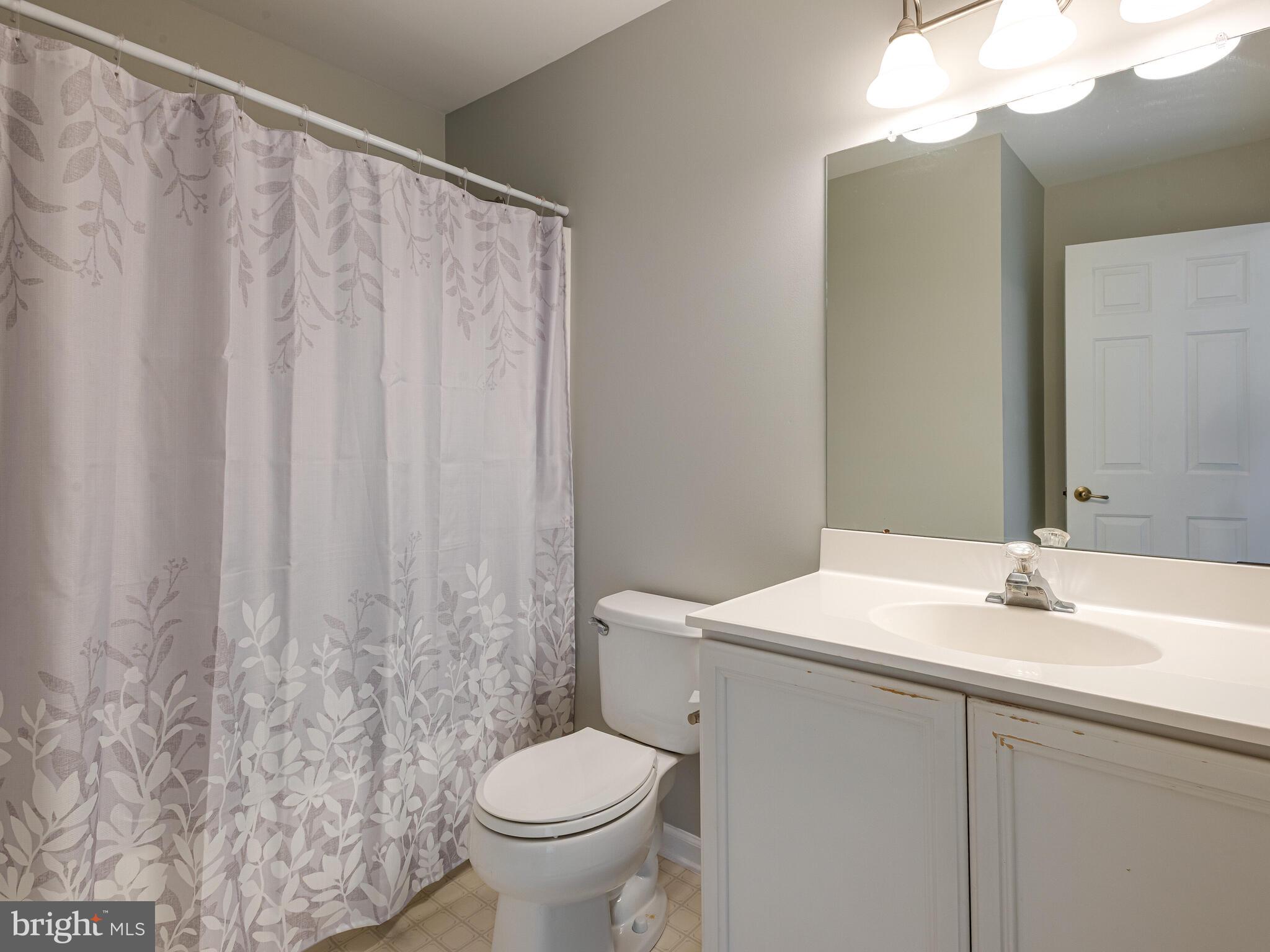 77 Buttonwood Drive, Unit 77 Exton, PA 19341 - Photo 27 of 29 a bathroom with a sink and a mirror