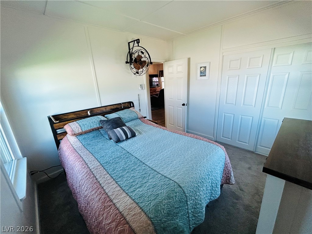 116 West Basic Road Henderson, NV 89015 - Photo 22 of 39 A comfortable bedroom featuring practical closet doors and soft carpet underfoot, creating a restful personal space.