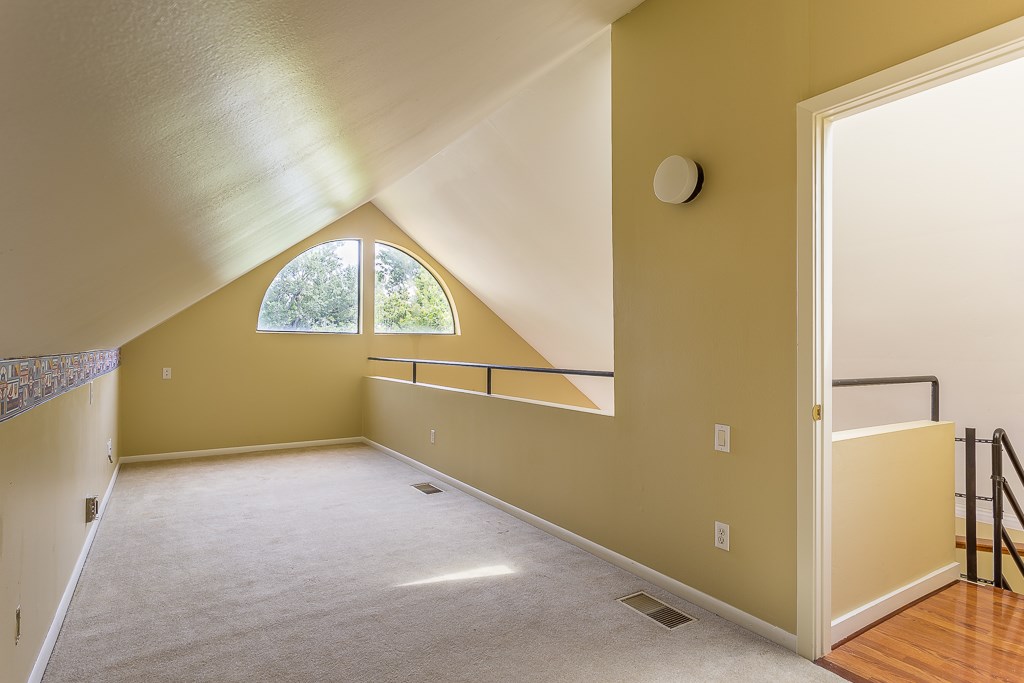 2349 Albans Road, Unit 2 Houston, TX 77005 - Photo 22 of 25 Discover a versatile upstairs flex space, perfect for a cozy study or an inviting extra bedroom/study, bathed in natural light from charming arched windows.
