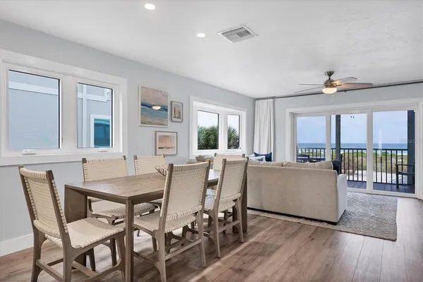 a dining room with furniture and wooden floor