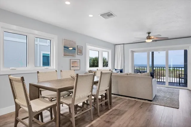 a dining room with furniture and wooden floor