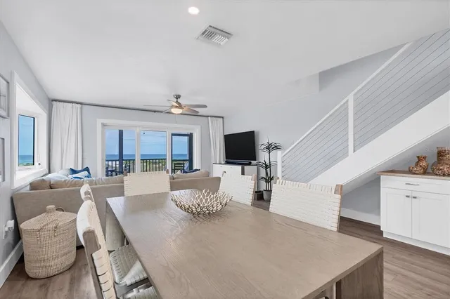 a living room with furniture a large window and a flat screen tv