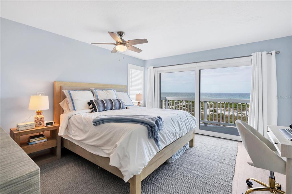 420 Gulf Boulevard, Unit 20 Boca Grande, FL 33921 - Photo 19 of 44 a bedroom with a bed and large window