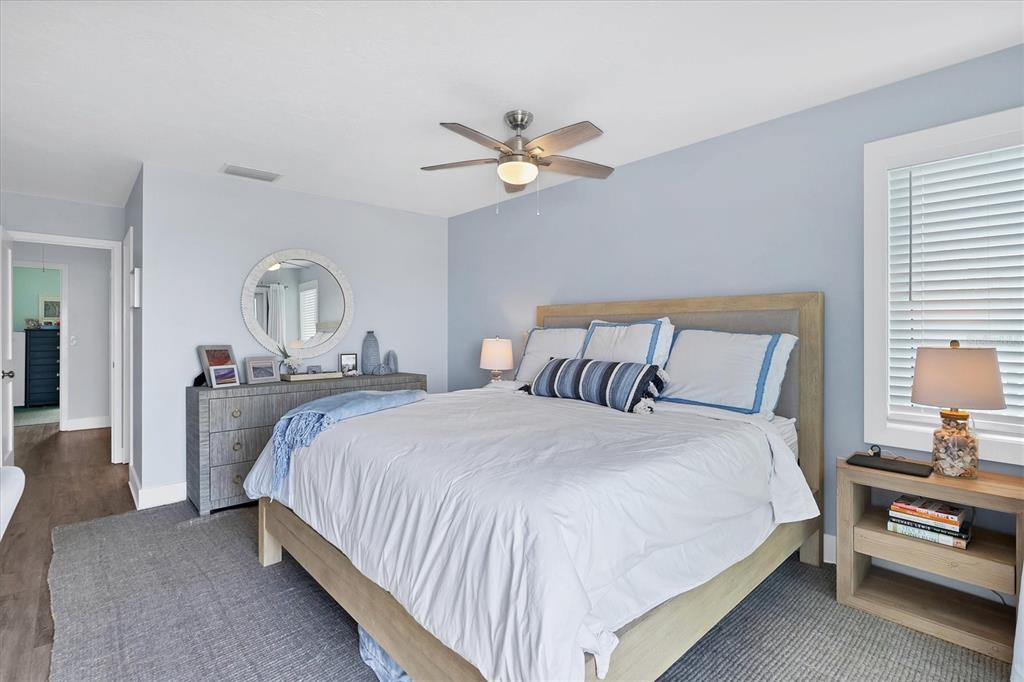 420 Gulf Boulevard, Unit 20 Boca Grande, FL 33921 - Photo 21 of 44 a bedroom with a bed and a chandelier