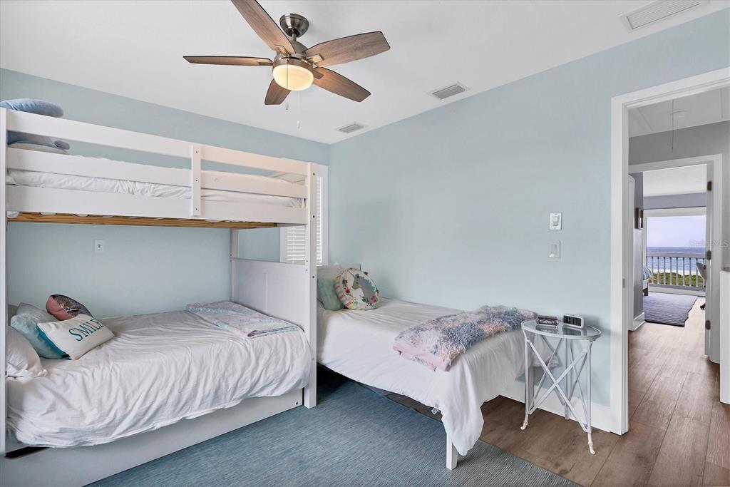 420 Gulf Boulevard, Unit 20 Boca Grande, FL 33921 - Photo 24 of 44 a bedroom with a bed and a chandelier