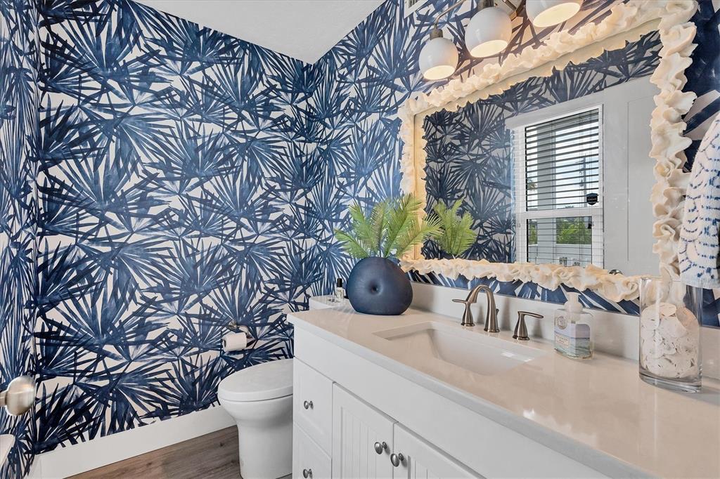 420 Gulf Boulevard, Unit 20 Boca Grande, FL 33921 - Photo 26 of 44 a bathroom with a granite countertop sink and a toilet