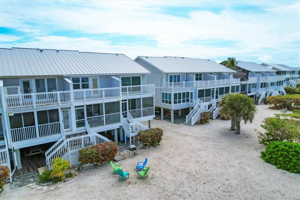 420 Gulf Boulevard, Unit 20 Boca Grande, FL 33921 - Photo 39 of 44 a front view of a building with a garden and entryway