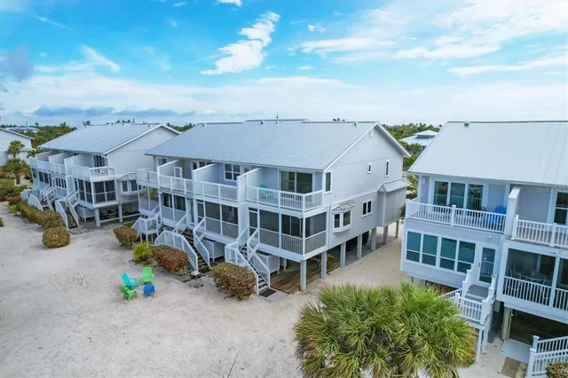 an aerial view of a house with swimming pool and sitting area