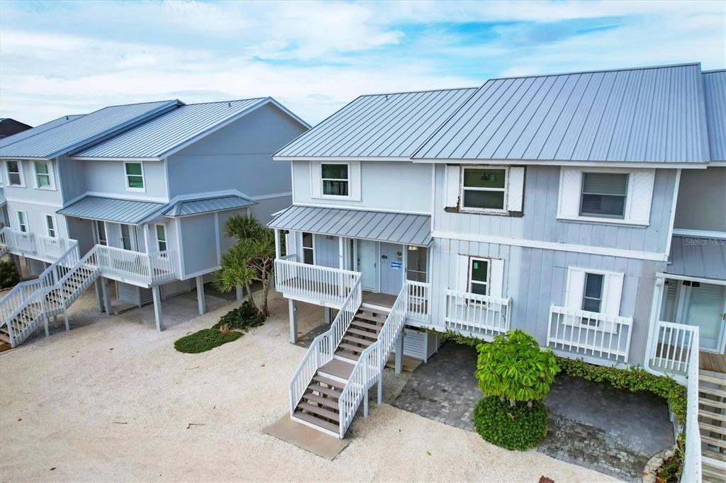 420 Gulf Boulevard, Unit 20 Boca Grande, FL 33921 - Photo 5 of 44 a front view of a house with a garage