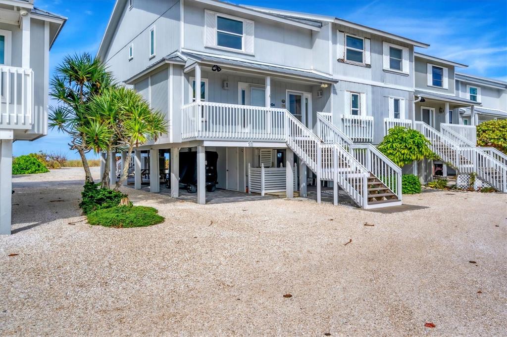 420 Gulf Boulevard, Unit 20 Boca Grande, FL 33921 - Photo 6 of 44 a front view of a house with a yard and garage