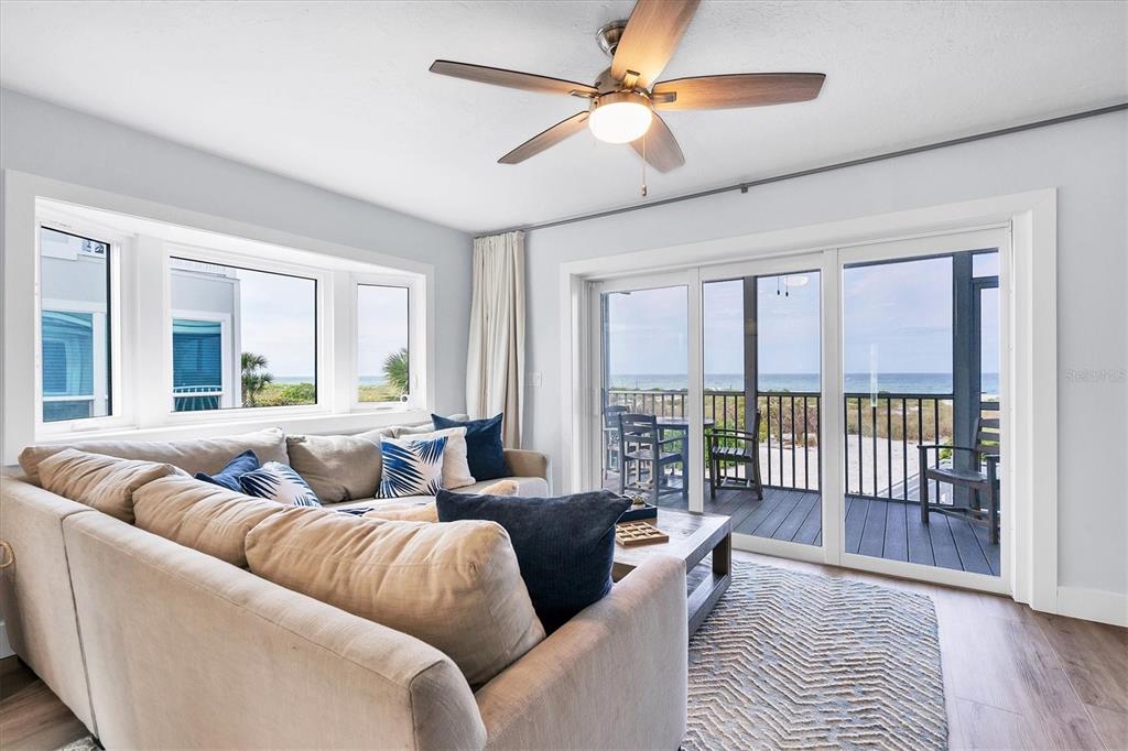420 Gulf Boulevard, Unit 20 Boca Grande, FL 33921 - Photo 7 of 44 a living room with furniture and a large window