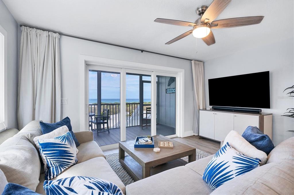 420 Gulf Boulevard, Unit 20 Boca Grande, FL 33921 - Photo 8 of 44 a living room with furniture and a flat screen tv