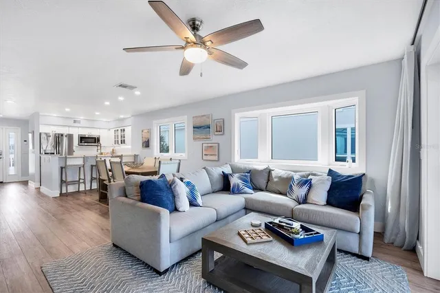a living room with furniture and view of kitchen