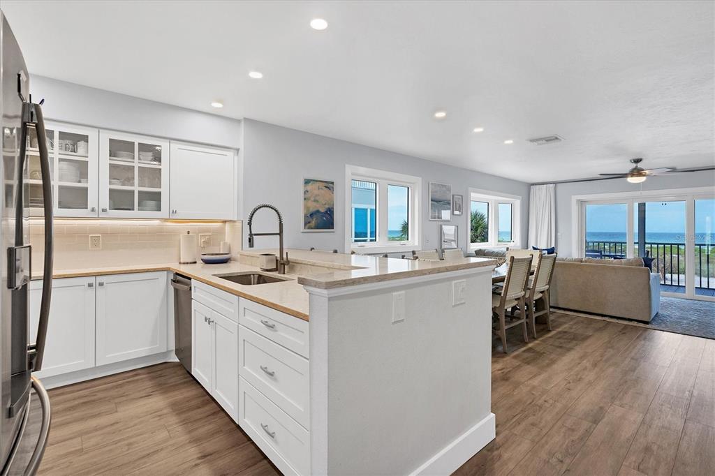 420 Gulf Boulevard, Unit 20 Boca Grande, FL 33921 - Photo 10 of 44 a kitchen with white cabinets and sink