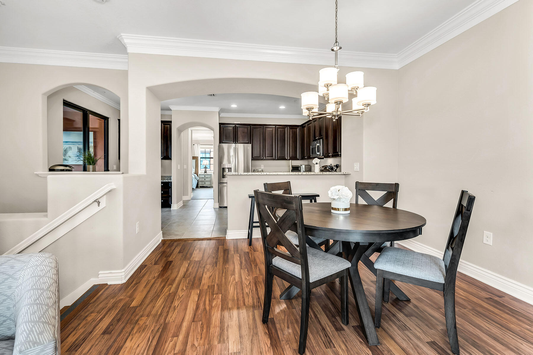 9066 Albion Lane North, Unit 5101 Naples, FL 34113 - Photo 14 of 48 a view of a dining room with furniture wooden floor and chandelier