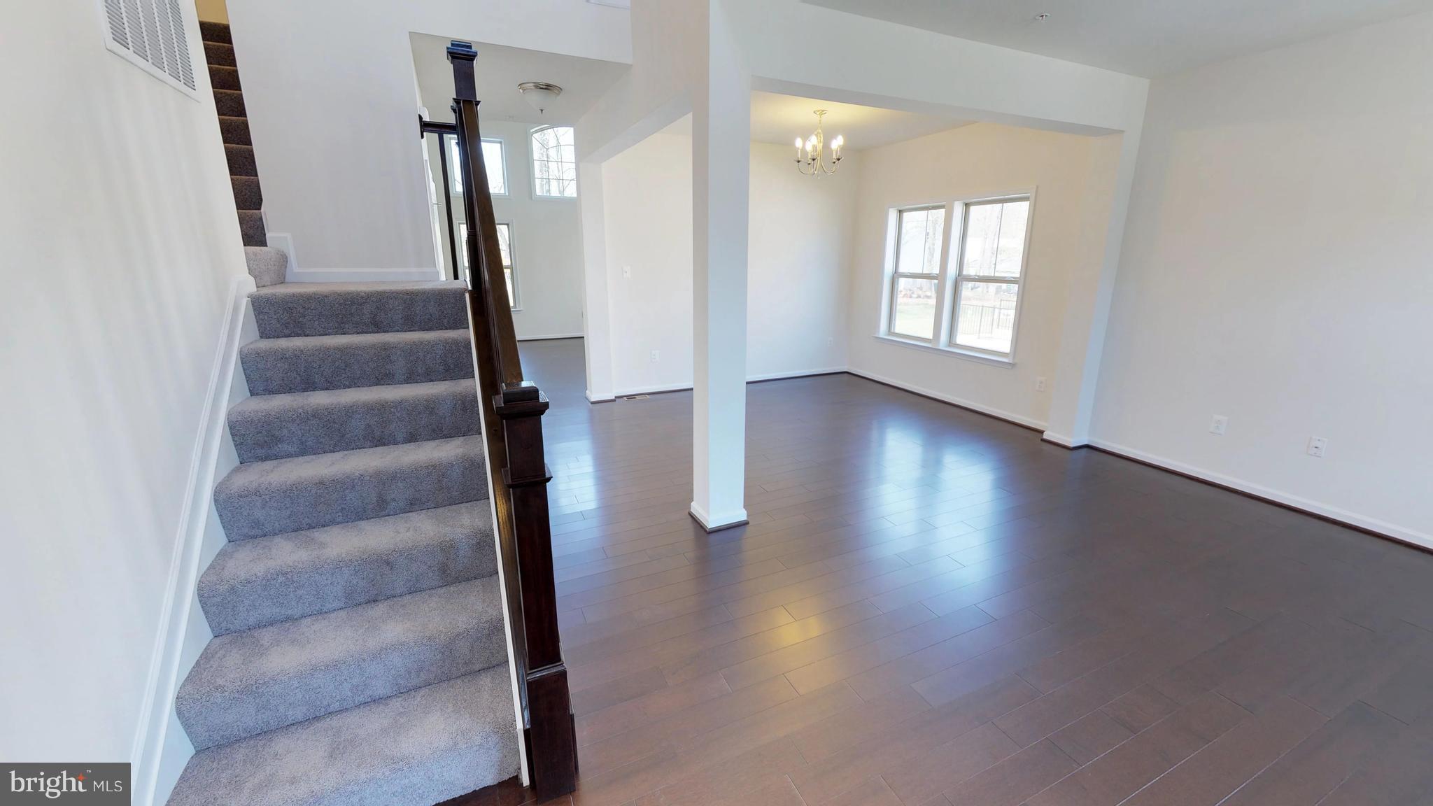 830 Janet Dale Lane Severn, MD 21144 - Photo 2 of 14 an empty room with wooden floor and windows