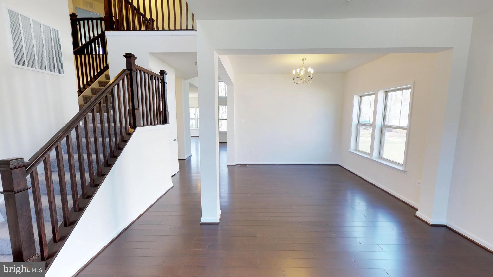 830 Janet Dale Lane Severn, MD 21144 - Photo 3 of 14 a view of a hallway with wooden floor and staircase