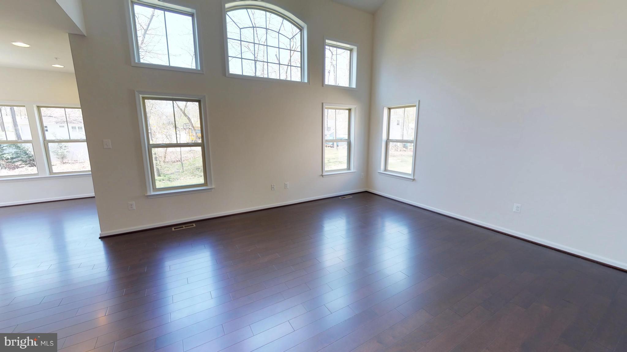 830 Janet Dale Lane Severn, MD 21144 - Photo 4 of 14 an empty room with wooden floor and windows