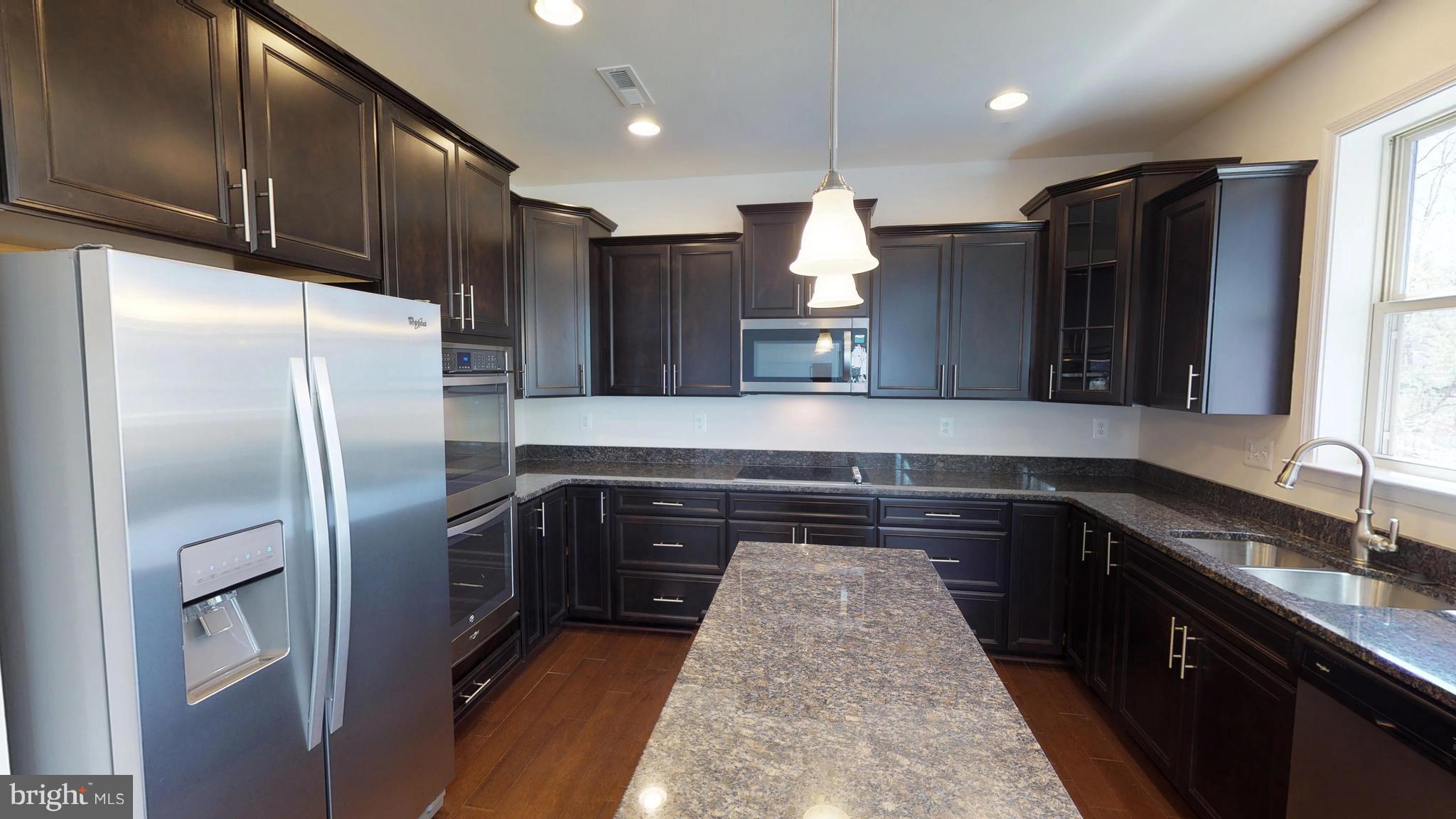830 Janet Dale Lane Severn, MD 21144 - Photo 5 of 14 a kitchen with granite countertop a refrigerator and a sink