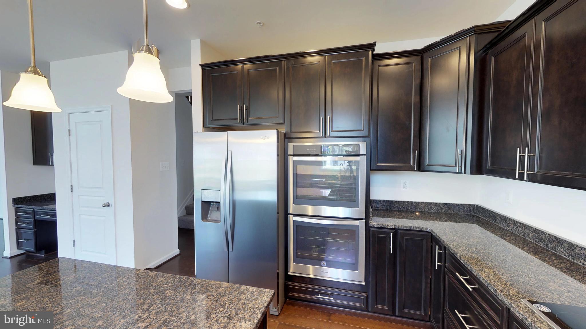 830 Janet Dale Lane Severn, MD 21144 - Photo 7 of 14 a kitchen with stainless steel appliances granite countertop a refrigerator and a sink