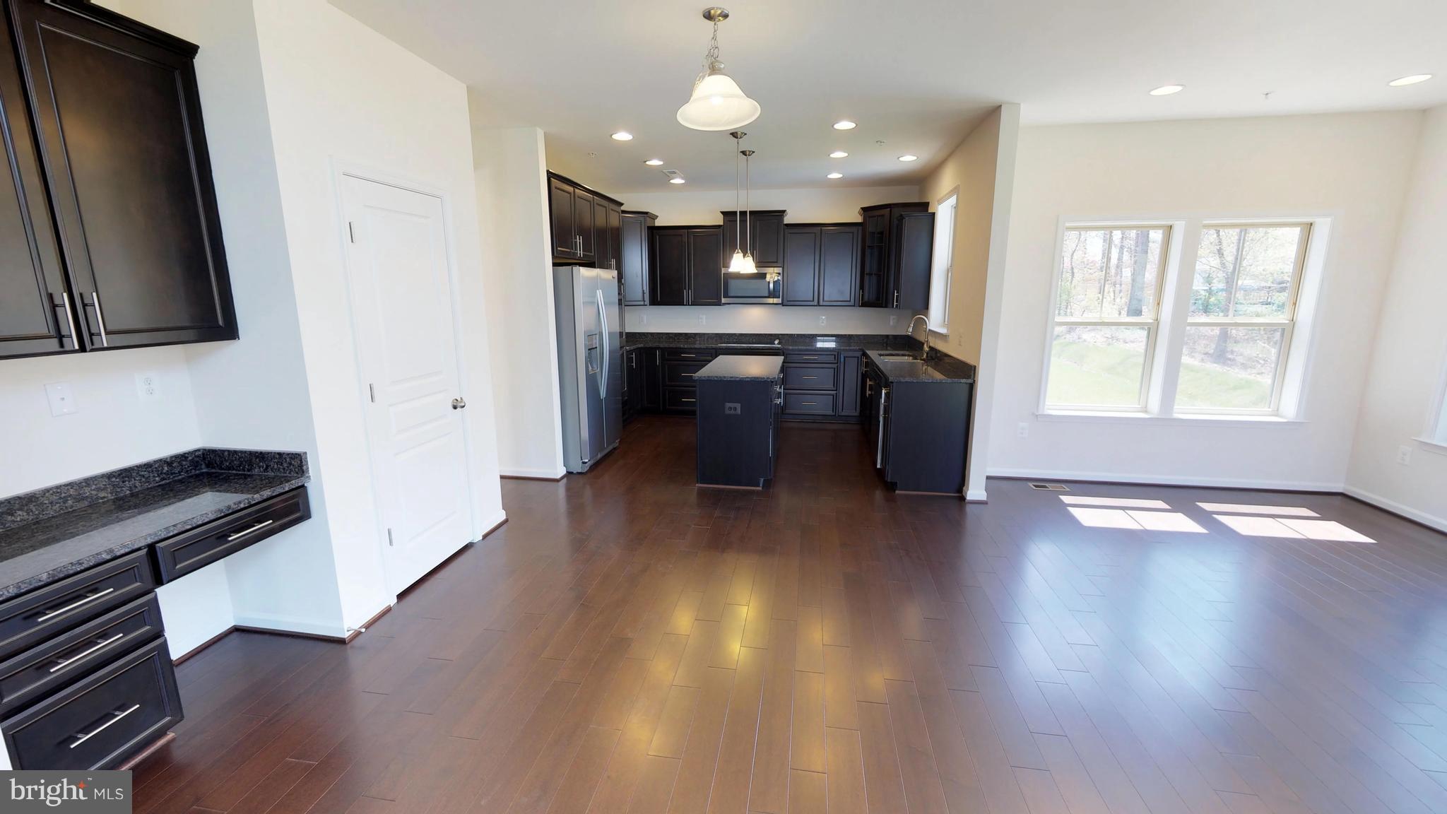 830 Janet Dale Lane Severn, MD 21144 - Photo 8 of 14 a view of a kitchen with a sink a refrigerator and a stove top oven