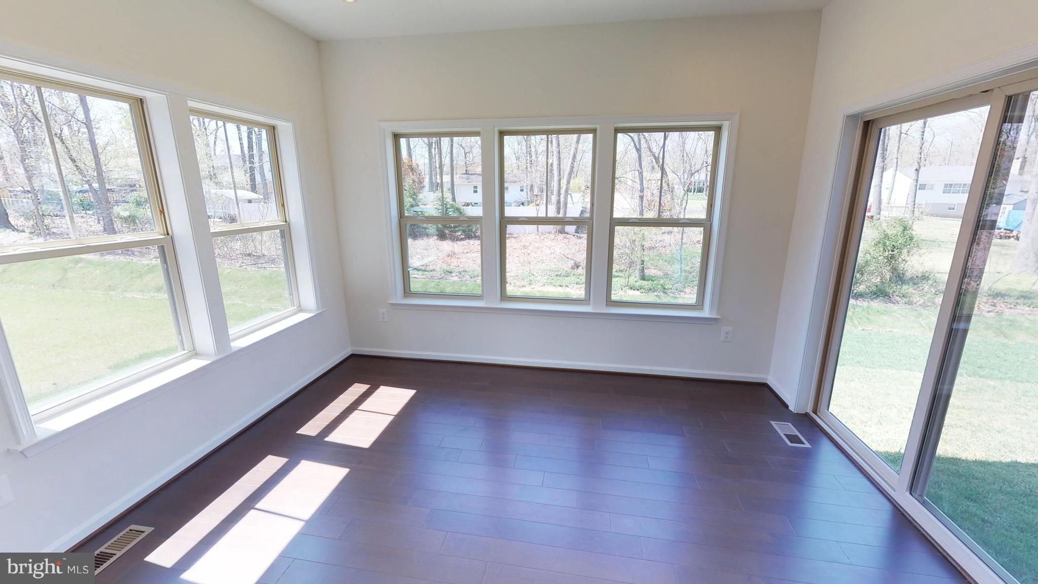 830 Janet Dale Lane Severn, MD 21144 - Photo 9 of 14 a view of an empty room with wooden floor and a window