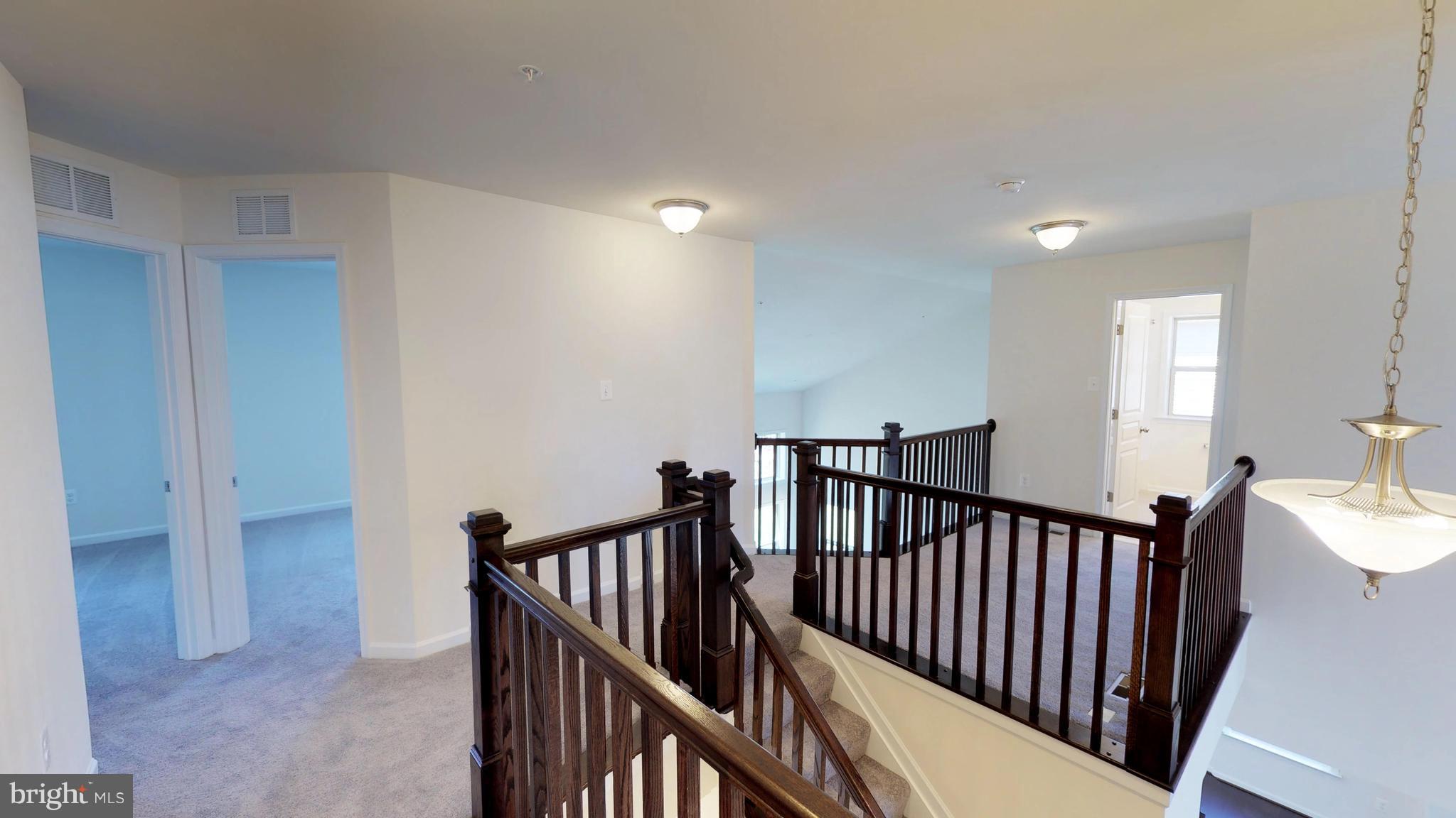830 Janet Dale Lane Severn, MD 21144 - Photo 10 of 14 a view of a hallway with dining room and stairs