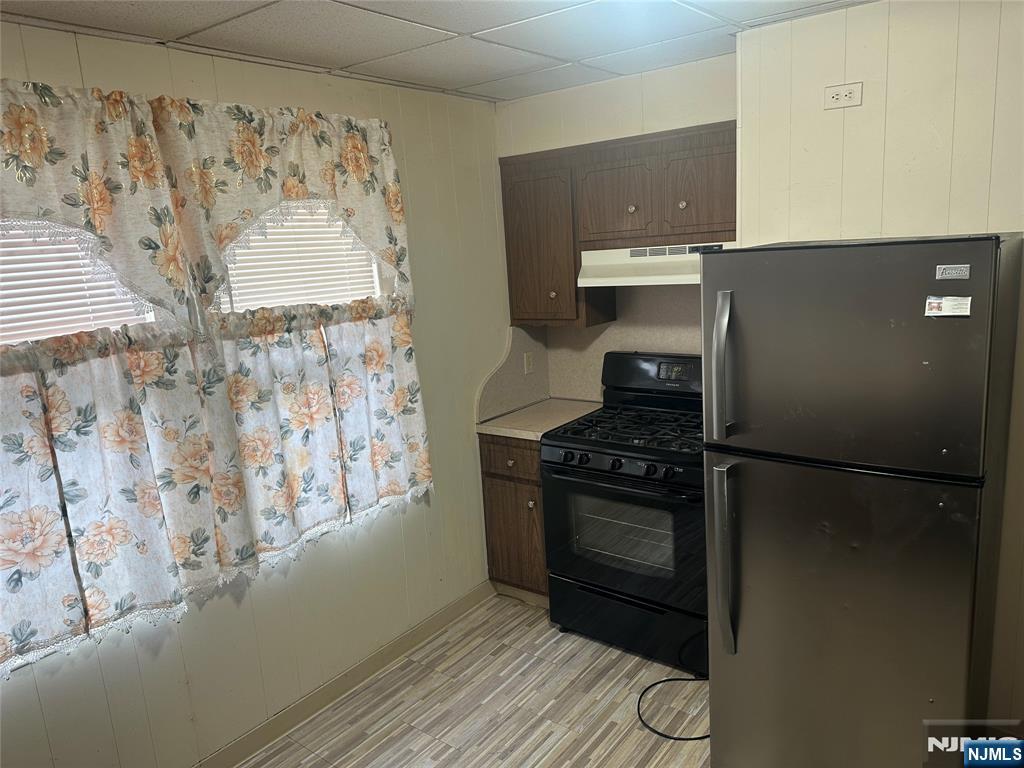 824 Paterson Avenue, Unit 2 East Rutherford, NJ 07073 - Photo 4 of 9 a kitchen with a wooden floor and a stove top oven