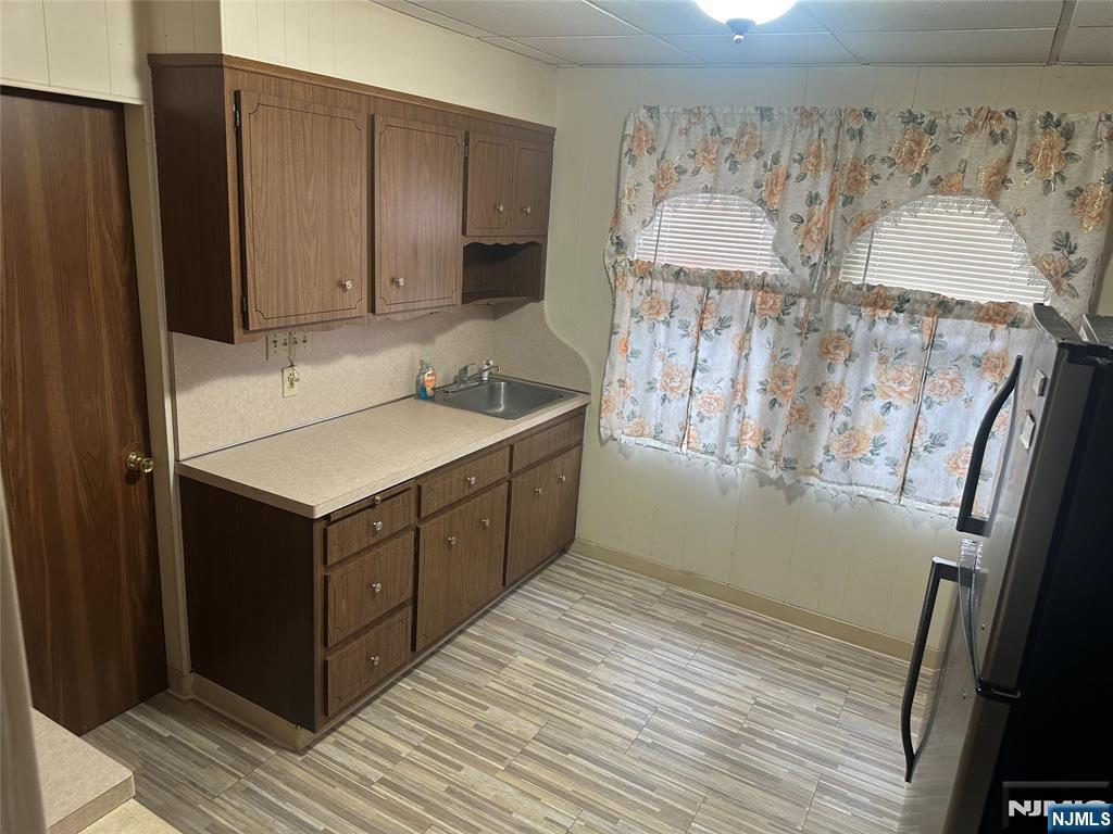 824 Paterson Avenue, Unit 2 East Rutherford, NJ 07073 - Photo 5 of 9 a kitchen with a sink cabinets and a window