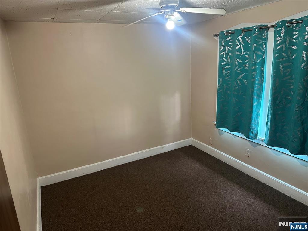 824 Paterson Avenue, Unit 2 East Rutherford, NJ 07073 - Photo 6 of 9 a view of a small space with wooden floor and a window