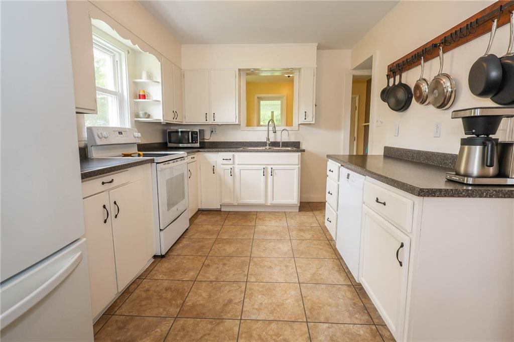 1265 Slippery Rock Road Grove City, PA 16127 - Photo 15 of 41 The dishwasher is on the right side with additional counter space and large hooks for all your pots and pans
