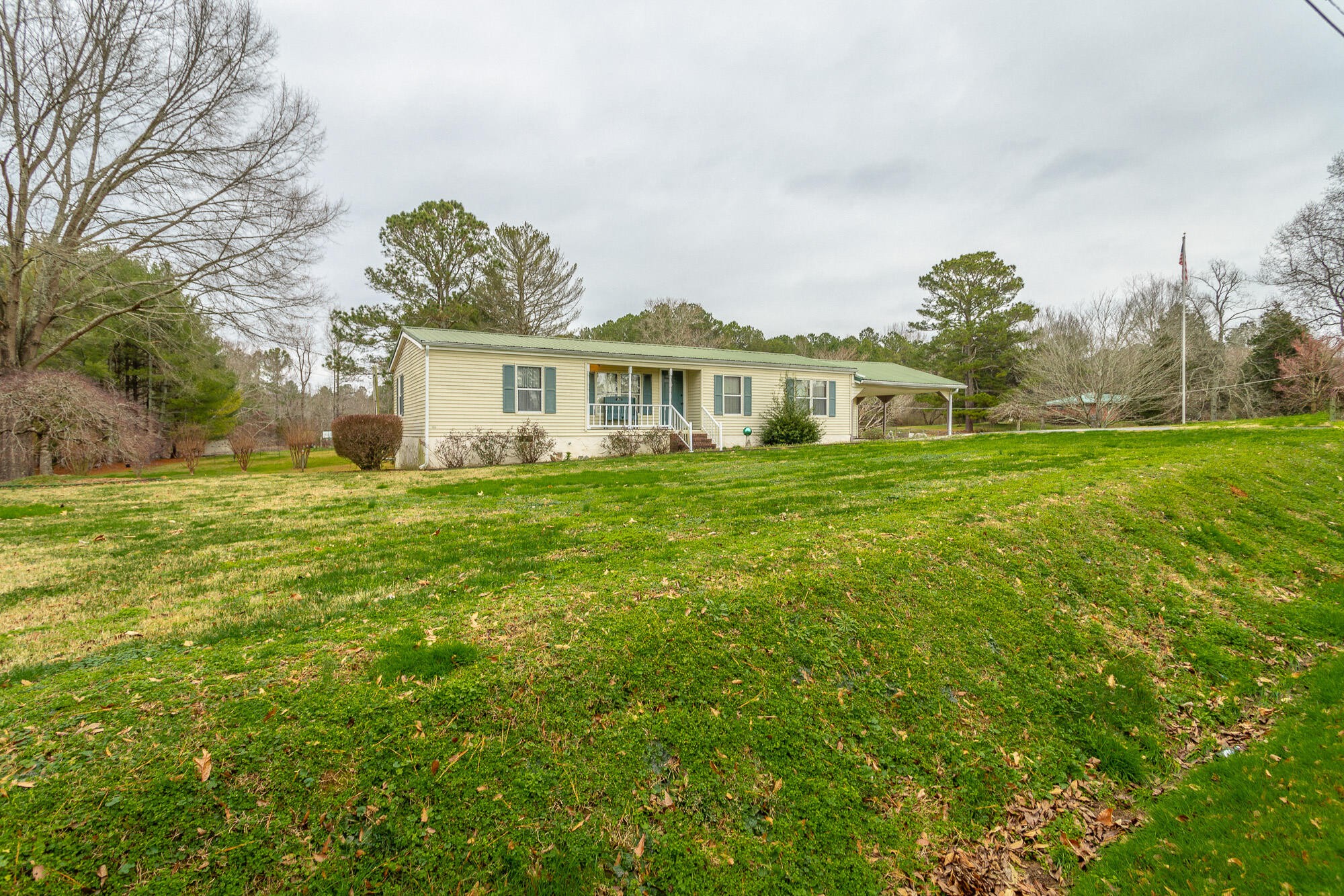 781 East Reed Road LaFayette, GA 30728 - Photo 8 of 73 a front view of a house with a garden and trees