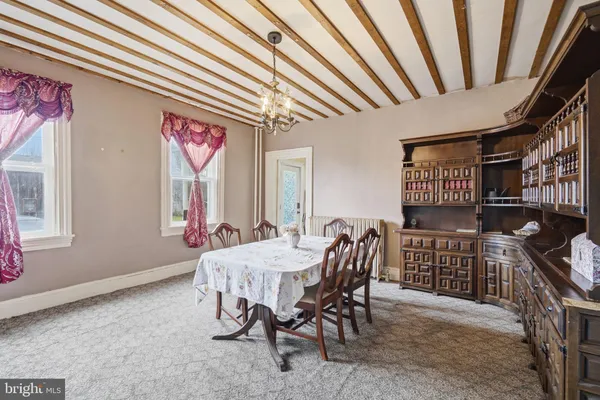 a dining room with furniture and window