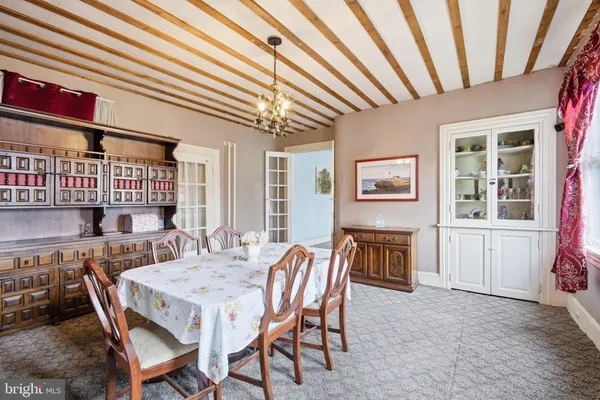 a dining room with furniture and window