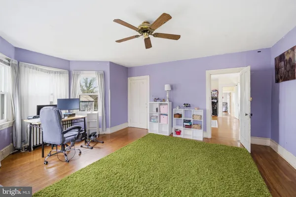 a view of a livingroom with workspace and a window