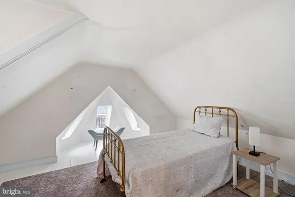 a view of a bedroom with wooden floor and stairs
