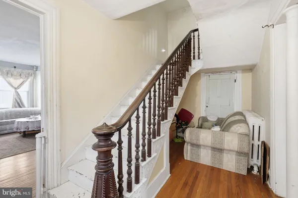 a view of staircase with wooden floor and chair