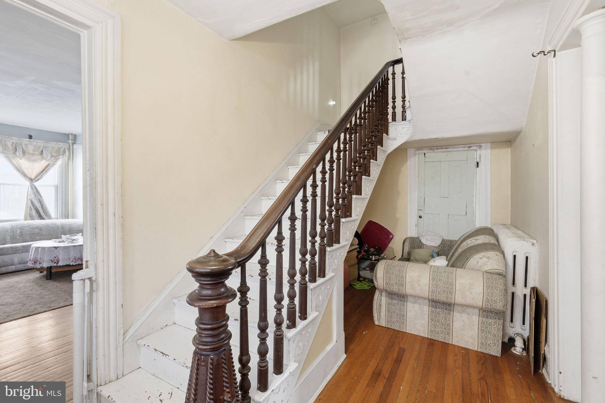 12733 Still Pond Road Still Pond, MD 21667 - Photo 7 of 21 a view of staircase with wooden floor and chair