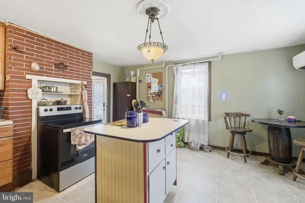 a kitchen with a table chairs a stove and cabinets