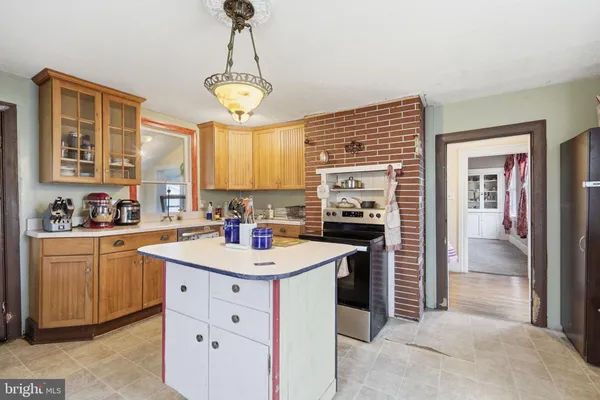 a kitchen with a stove a sink and a refrigerator