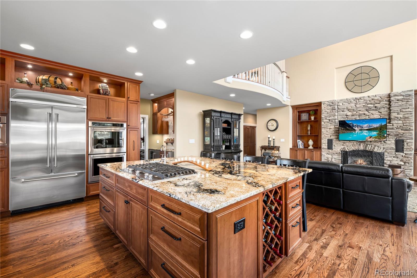 71 North Ranch Road Littleton, CO 80127 - Photo 13 of 40 a kitchen with stainless steel appliances granite countertop a stove and a refrigerator