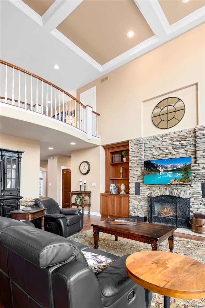71 North Ranch Road Littleton, CO 80127 - Photo 14 of 40 a living room with furniture a fireplace and a large window